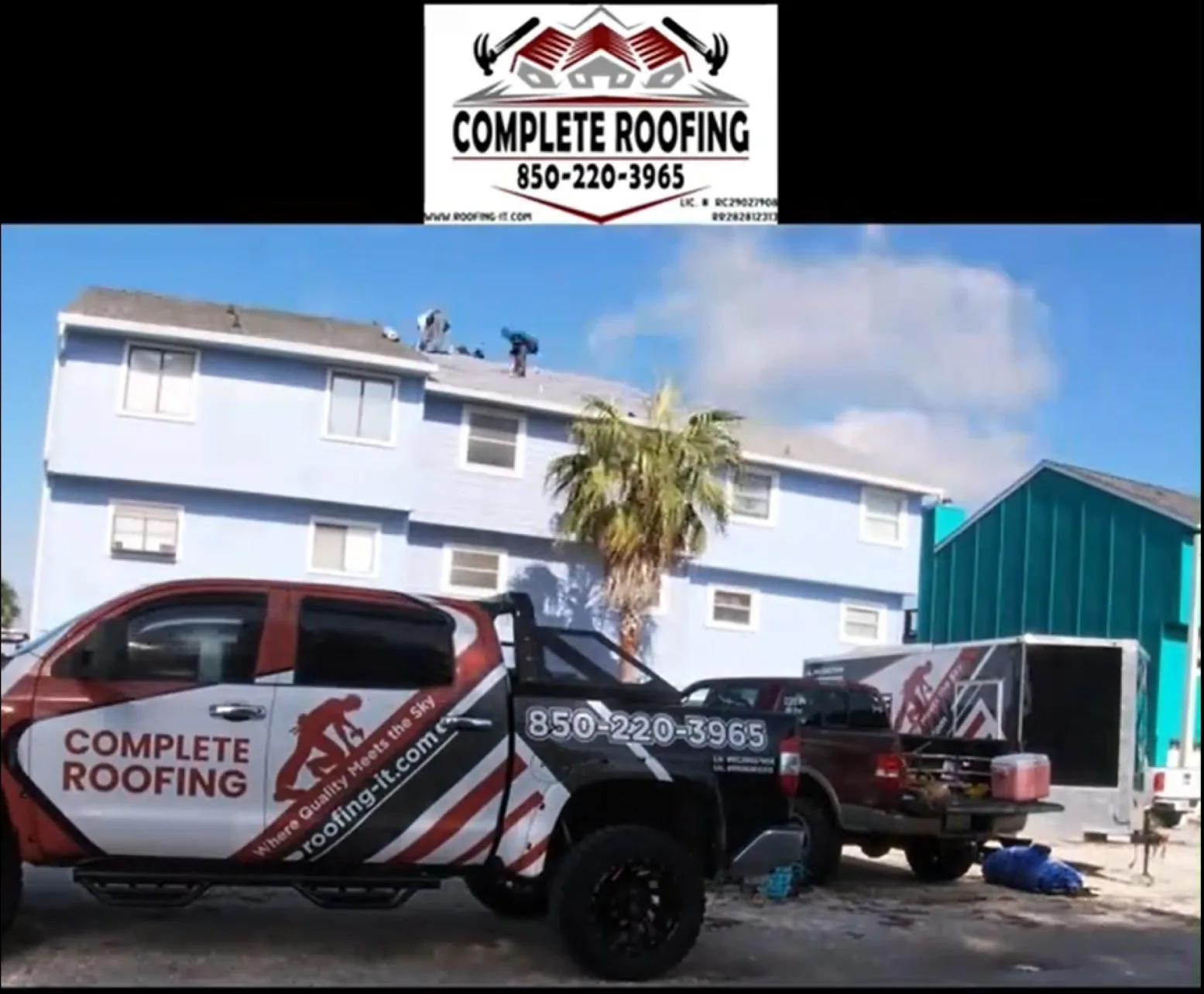 Complete Roofing crew replacing the roof on a three-story beachfront home with company truck parked out front