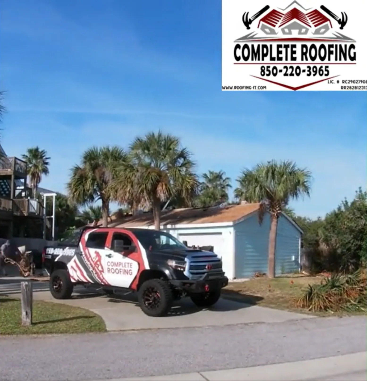 Complete Roofing truck parked in front of a Pensacola Beach waterfront home with new GAF Timberline HDZ shingle roof