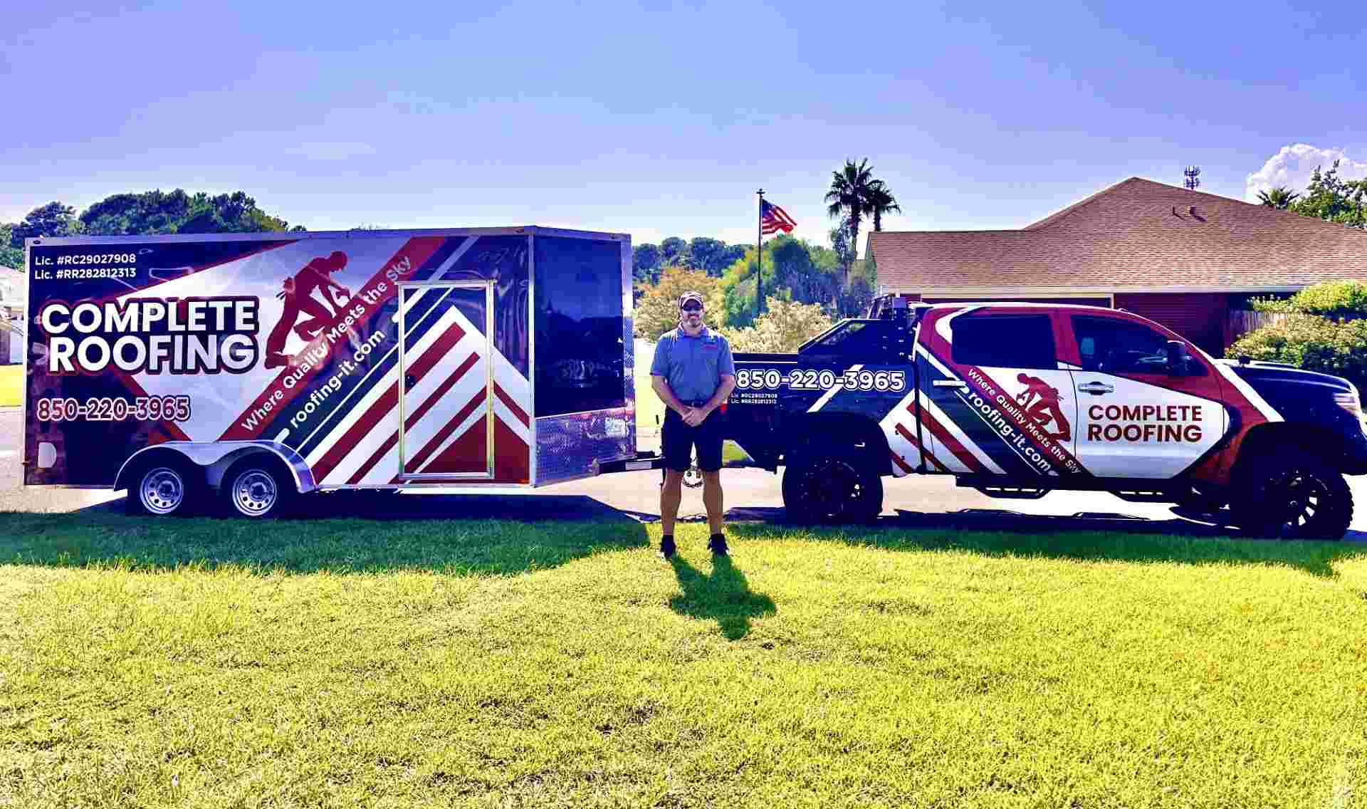 Jason Taylor with the Complete Roofing LLC company truck and trailer on a Gulf Breeze, Florida job site